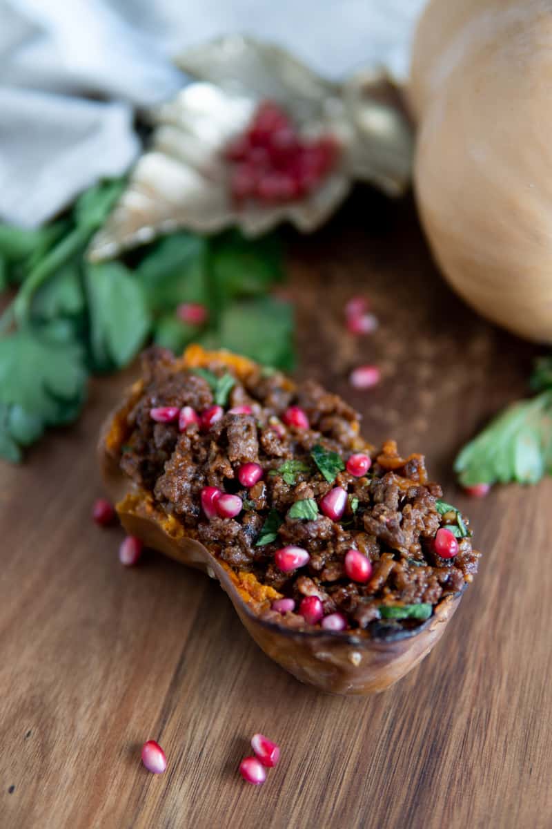 half of roasted honeynut squash stuffed with ground beef
