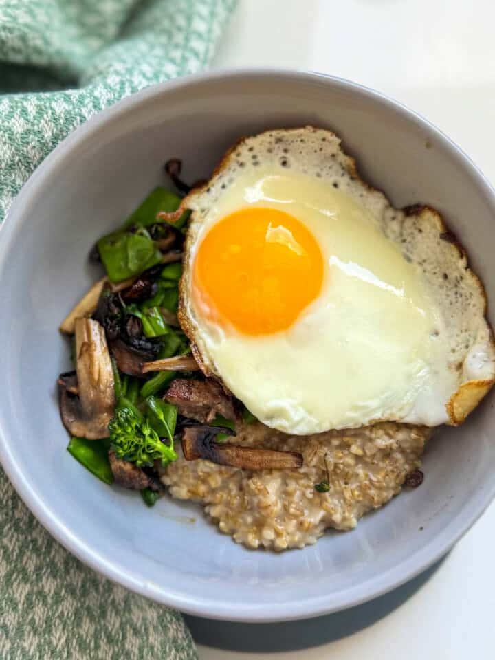 bowl with steel cut oats, vegetables and jammy egg.